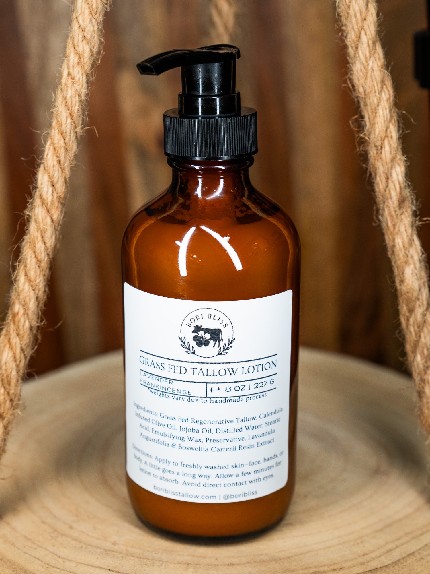 An 8oz bottle of Bori Bliss Grass Fed Lavender Frankincense Tallow Lotion, a lightweight, non-greasy body moisturizer.