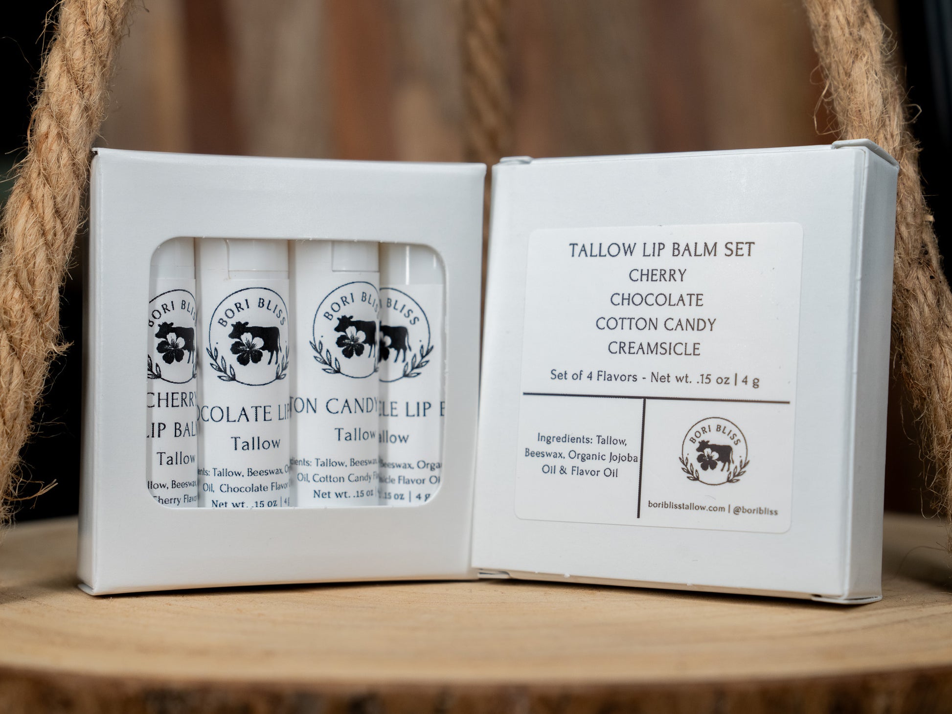 Set of four Bori Bliss sweet shoppe tallow lip balm tubes in a box. Cherry, chocolate, cotton candy, and creamsicle.